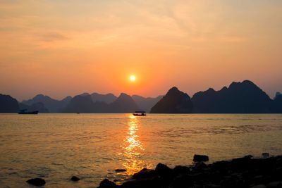 Scenic view of sea against romantic sky at sunset