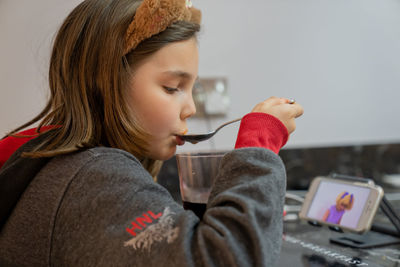 Side view of young woman using phone