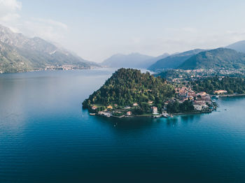 Scenic view of sea and mountains against sky