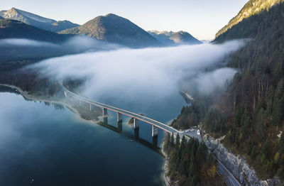 Fog moving over sylvenstein dam in winter, bad tolz, bavaria, germany