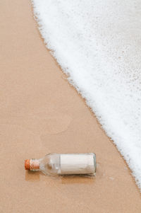 High angle view of bottle on beach