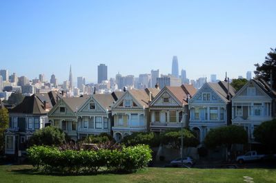Buildings in city against clear sky