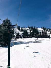 Ski lift against clear sky during winter