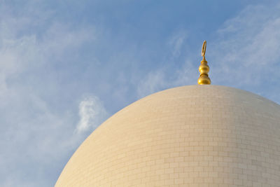 Low angle view of a building against cloudy sky