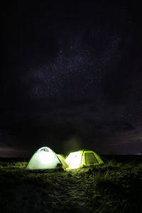 Tent on field against sky at night