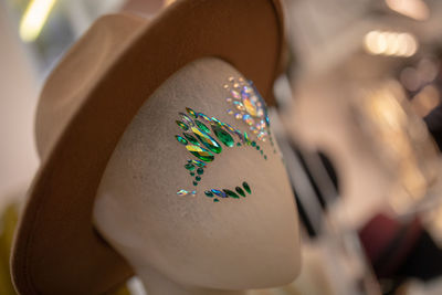 Close-up of mannequin with hat and decoration