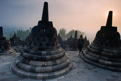 View of ancient temple against sky during sunset