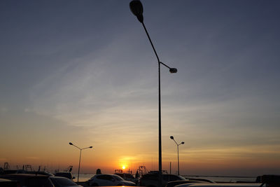 Low angle view of silhouette street against sky at sunset
