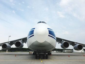 Airplane on runway against sky