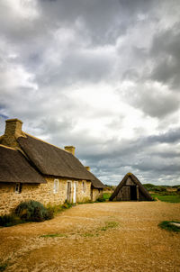 Houses on field against sky