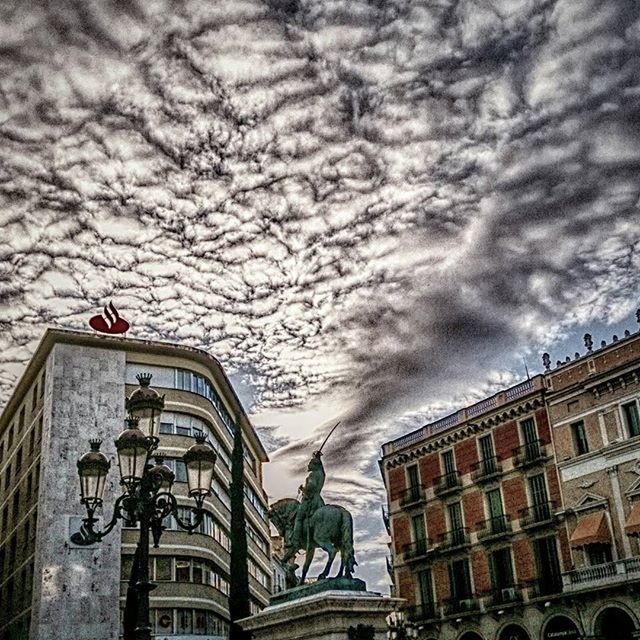 architecture, building exterior, built structure, sky, low angle view, cloud - sky, cloudy, building, weather, city, cloud, window, overcast, residential building, residential structure, day, outdoors, street light, no people, city life