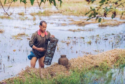 Full length of man standing in lake