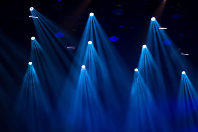 Stage lights glowing in the dark at a live concert. music festival concept