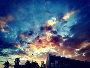 Low angle view of dramatic sky over city