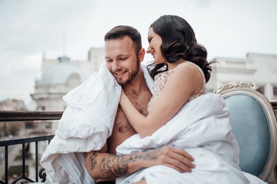 Rear view of couple sitting outdoors