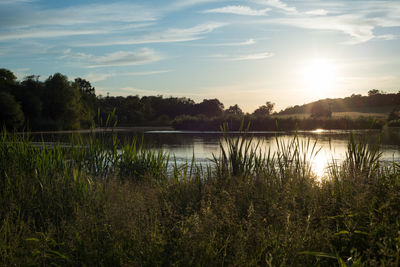 Scenic view of lake against sky during sunset