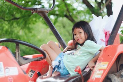 Portrait of girl sitting in truck