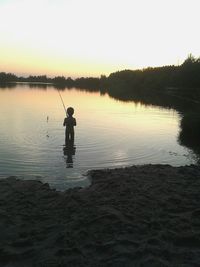 Scenic view of lake at sunset