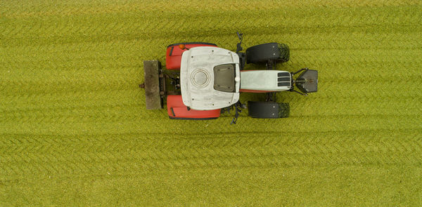 Agricultural machinery tractor and chopper during the corn harvest