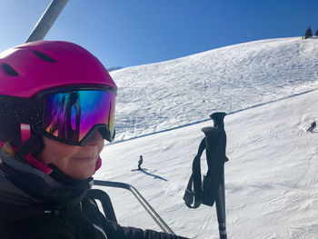 Woman with skiing poles on snowcapped mountain