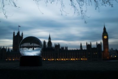 Illuminated building against sky at dusk