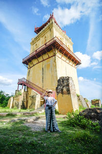 Full length of man standing by building against sky