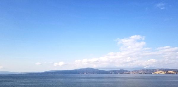 Scenic view of sea against blue sky