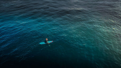 High angle view of man swimming in sea