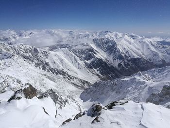 Scenic view of snow mountains against sky