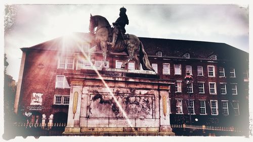 Low angle view of statue against building