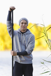 Portrait of man holding oar outdoors
