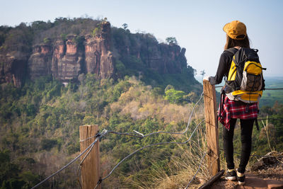 Rear view of man standing on rock