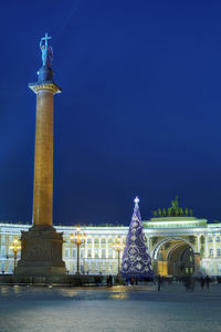 Statue of illuminated building against blue sky