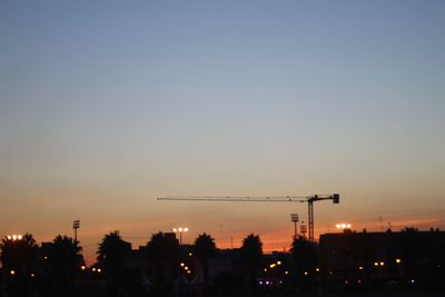 Silhouette of buildings against sky at sunset