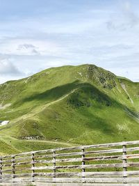 Scenic view of green landscape against sky