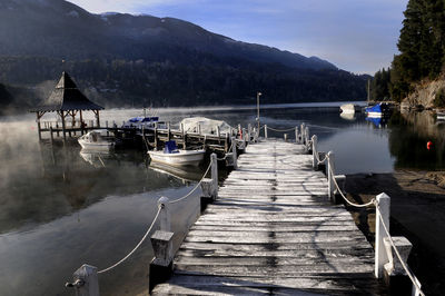 Pier over lake against sky