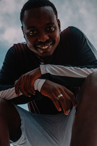 Portrait of smiling young man standing outdoors