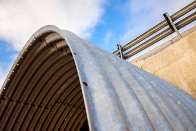 Low angle view of metallic structure against sky