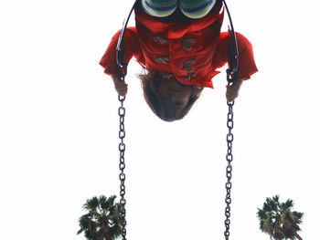 Low angle view of girl on swing