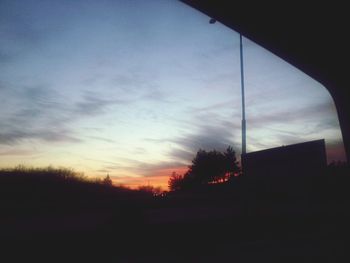 Silhouette trees against sky at sunset