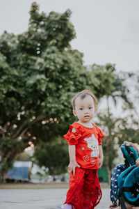 Portrait of cute girl standing on land