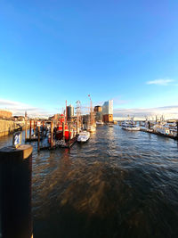 Boats in sea against buildings in city