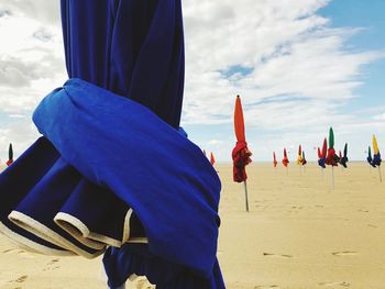 People at beach against sky