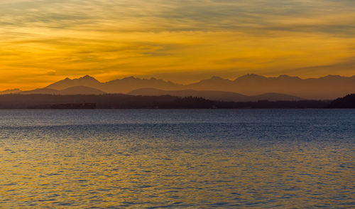 Olympic mountain range across the puget sound at sunset.