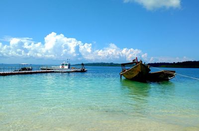 Nautical vessel on sea against blue sky