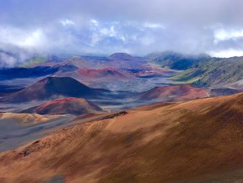 Scenic view of mountains against cloudy sky