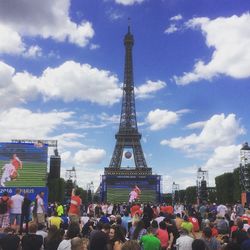 People at town square against cloudy sky