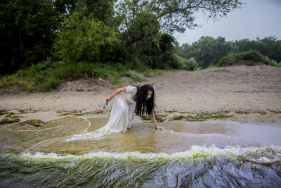 Full length of woman on shore