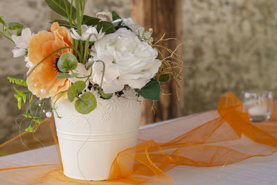 Close-up of white rose flower vase on table