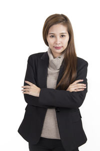 Portrait of smiling young woman against white background